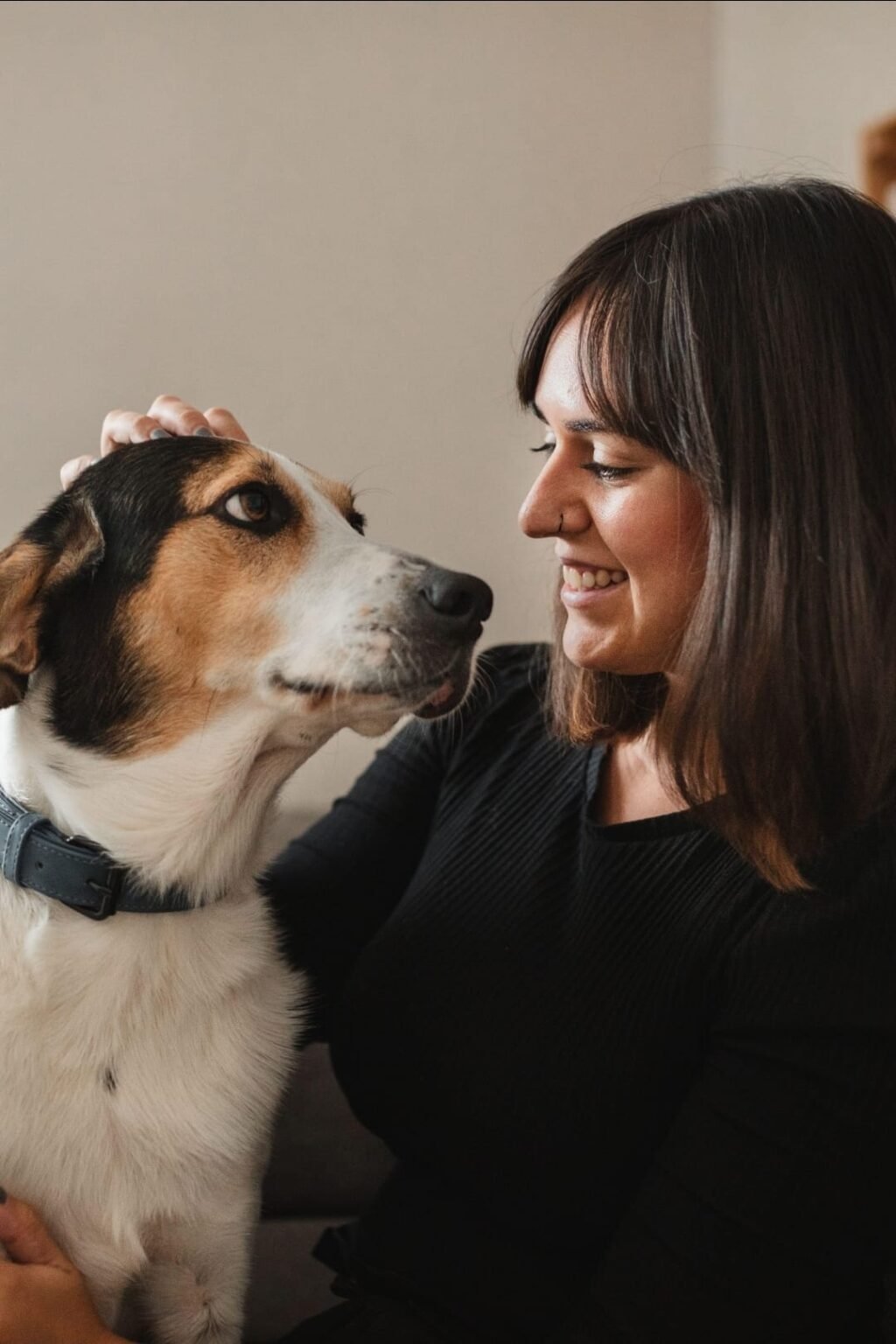 Woman looking at her dog while enjoying time together